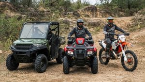 New 2026 Polaris, Honda, KTM Off-Road Vehicles - Dirt Legal 2026 Polaris RANGER 1000, Honda FourTrax Rubicon ATV, and KTM 300 XC-W dirt bike parked on a dirt trail with riders.
