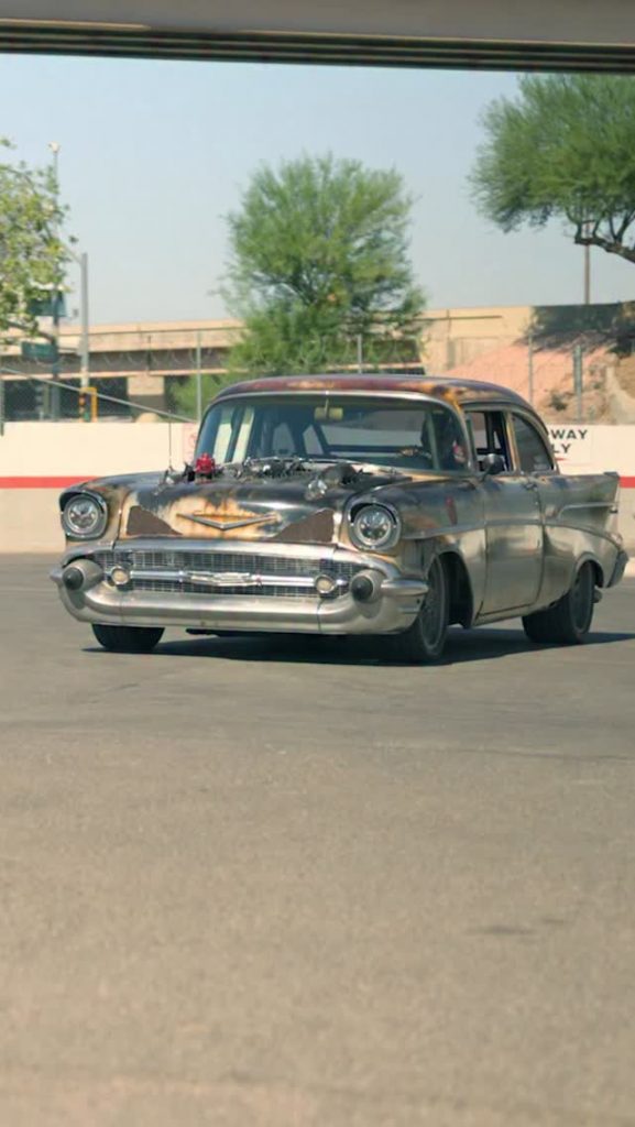 Custom-built Frankenstein car made from salvage parts driving on road after reconstructed vehicle registration