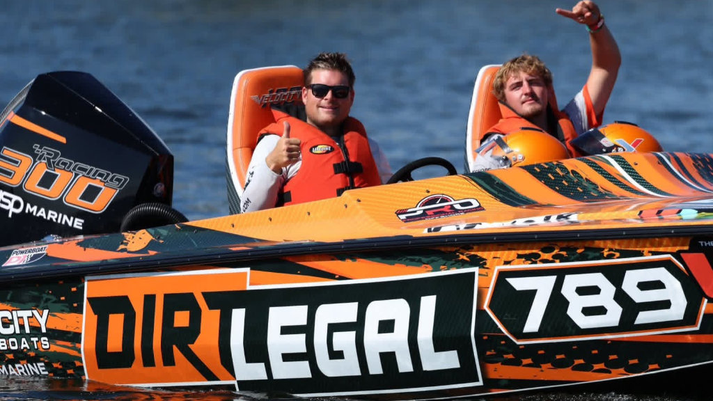 Brad Christopher and Connor Langheim giving a thumbs up from the cockpit of the #789 Team Dirt Legal offshore racing boat.