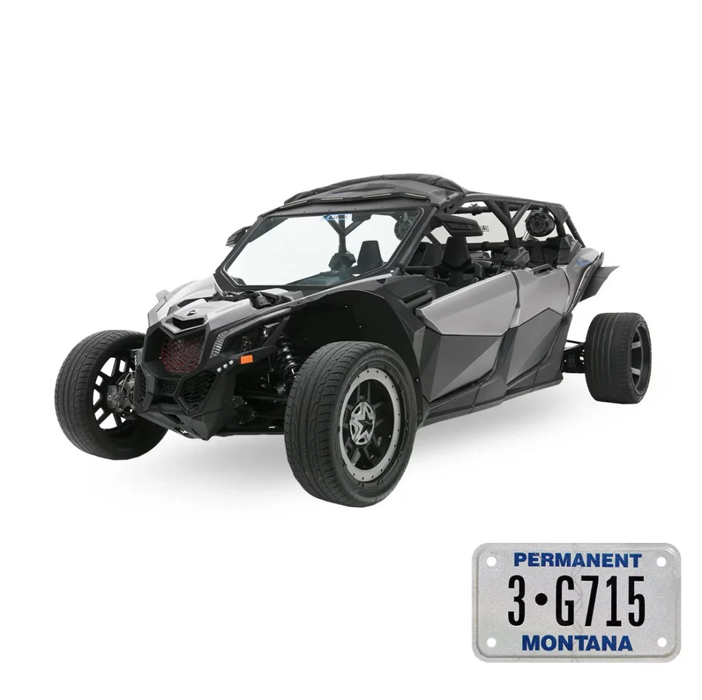 Grey and black three-wheeled convertible vehicle with two front wheels and one rear wheel on a white studio background; Montana license plate visible in the bottom-right corner.