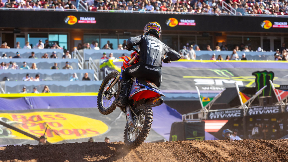 Anthony Rodriguez on KTM number 123 launching off a dirt jump at Rice-Eccles Stadium during the 2026 Monster Energy Supercross season finale