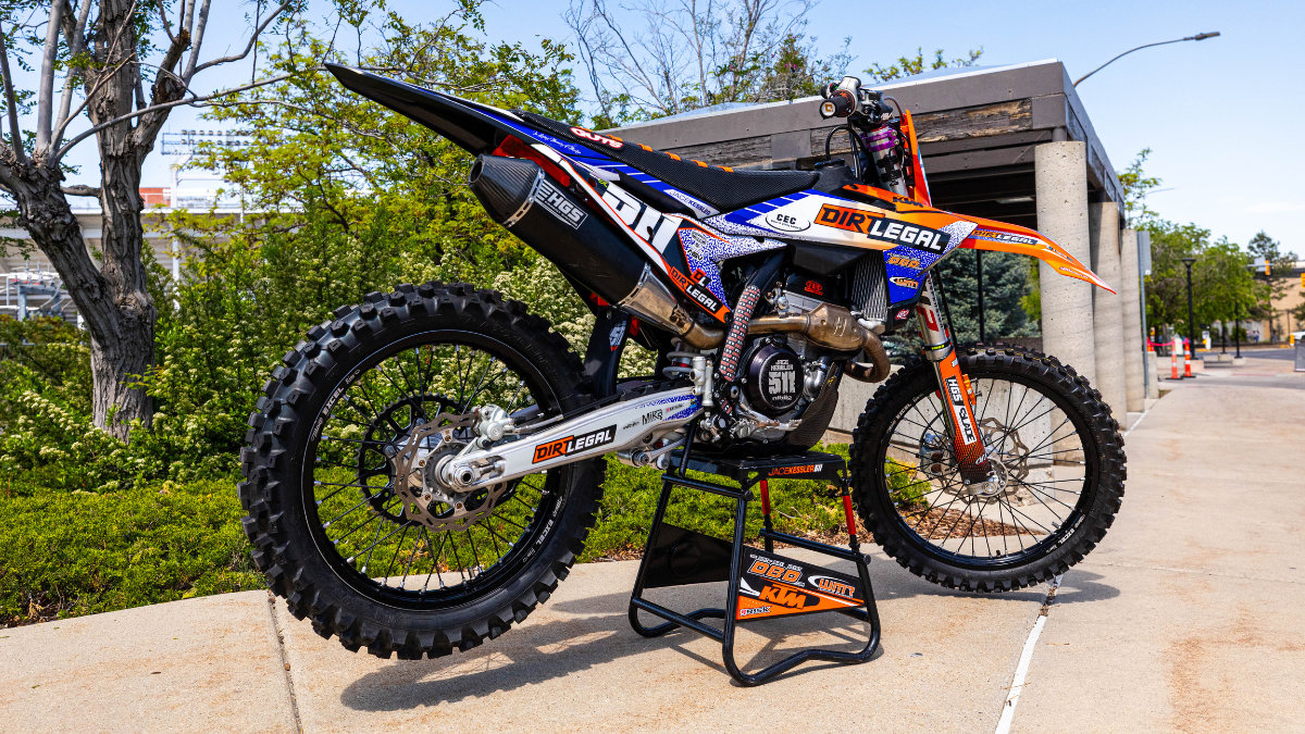 Dirt Legal branded KTM motocross bike on a stand outside Rice-Eccles Stadium ahead of the 2026 Salt Lake City Supercross finale