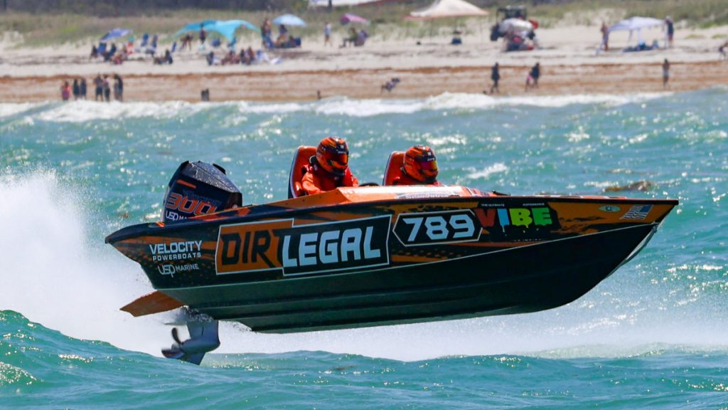 Dirt Legal Velocity boat #789 lifting off the water nose-up during the Thunder on Cocoa Beach offshore race, showing the full Dirt Legal and Velocity Powerboats sponsorship livery