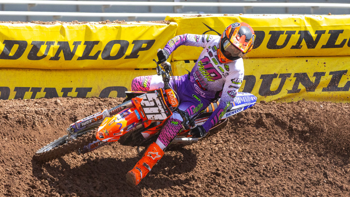 Jace Kessler on the Dirt Legal KTM carving a hard left berm in front of Dunlop banners during the 2026 Salt Lake City Supercross