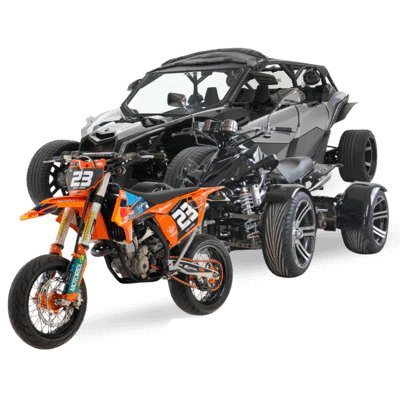 Orange KTM motocross bike with number 23 in front of a black off-road dune-buggy chassis.