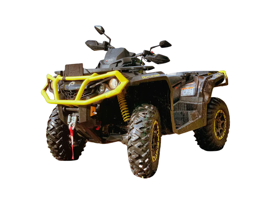 All-terrain vehicle with a bright yellow bumper, large knobby tires, and muddy body.
